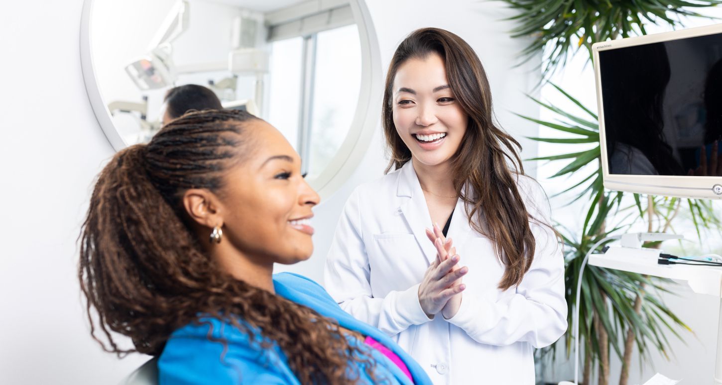 Dentist conversing with patient in clinic.